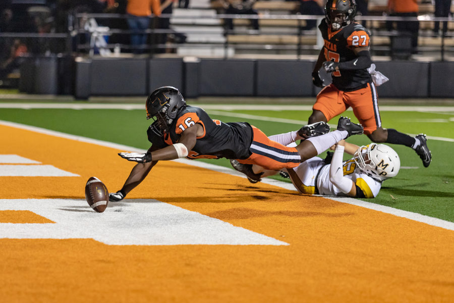 Linebacker Ean Crite dives over a Mt. Pleasant player for a loose ball in the end zone after a botched play. Crite recovered the ball for a touchdown.