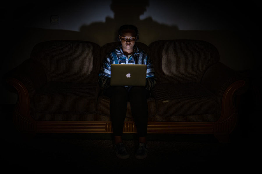 Sophomore Truth Dukes works on a laptop during school in the dark. Many people this year are readjusting to the in-person learning environment.