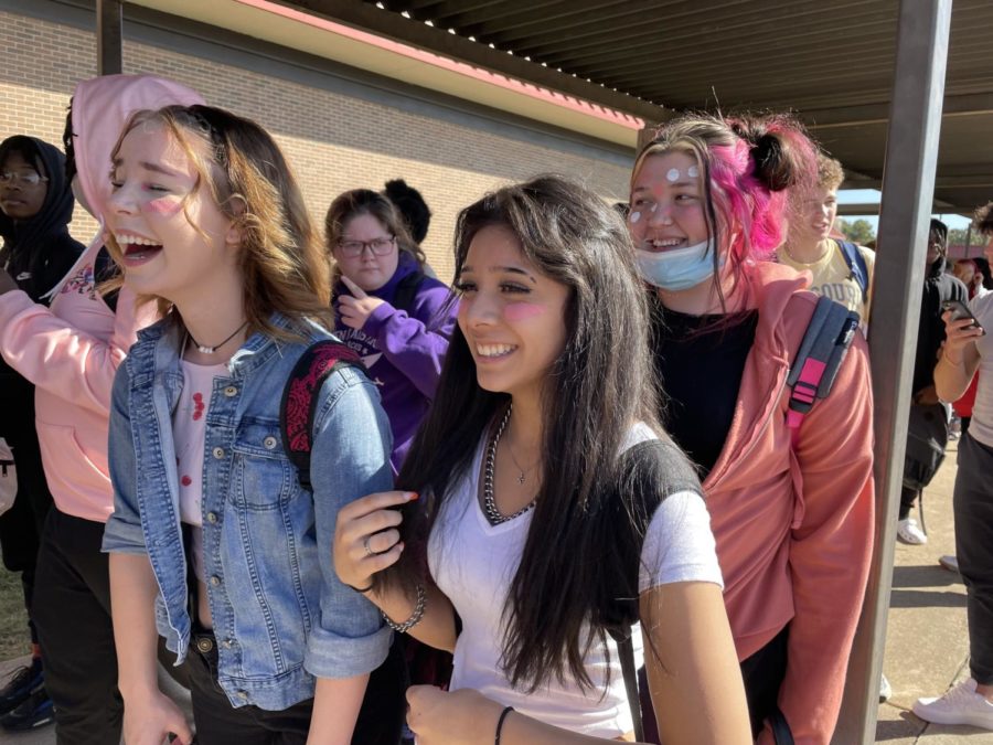 In line to enter the pep rally Oct. 22, juniors Emily Richey, Liv Balderas and Cindy Britton show their support for breast cancer awareness by wearing pink. Students wore different colors each day of the week in order to bring awareness to the many types of cancer.