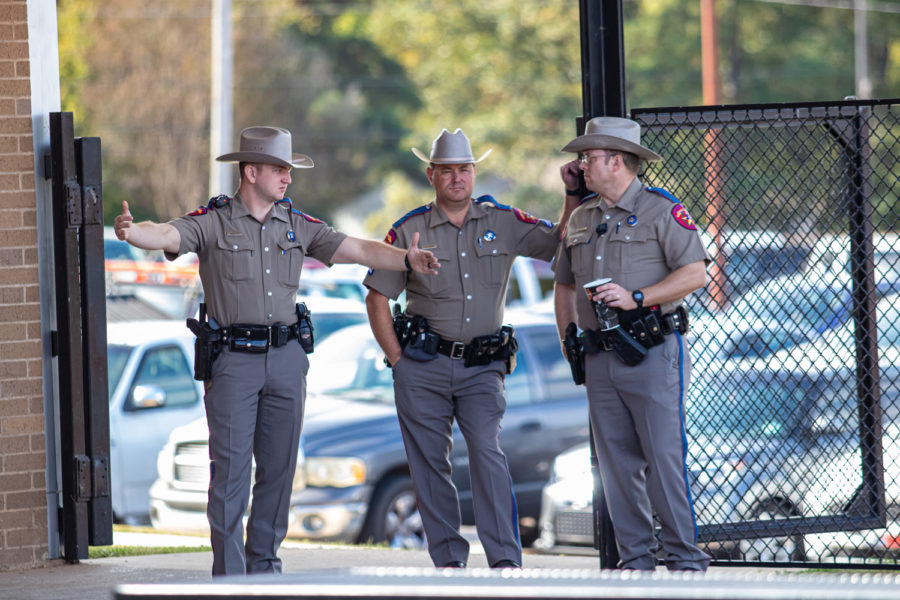 Texas Department of Public Safety State Troopers stand at one of the entrances to the cafeteria area at Texas High School. Troopers and other area law enforcement provided extra security after the off campus shooting death of a Texas High School student.
