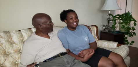 Senior Margaret Mutoke lounges on a couch with her deceased grandfather
