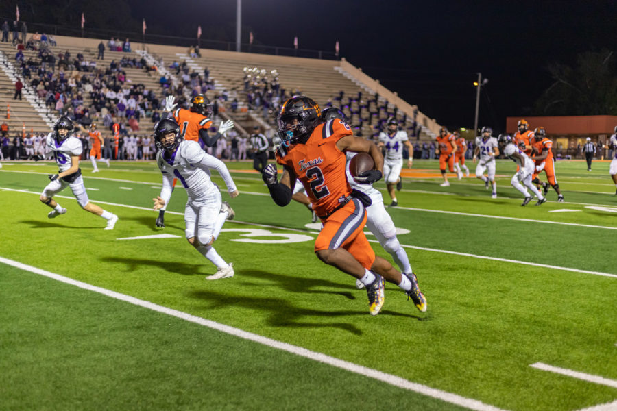 Runningback Braylon Stewart rushes down the home sideline scoring a touchdown in the third quarter against Houston Fulshear in the 2021 Bi-Distrcit playoff game at Tiger Stadium on Nov. 11. The Tigers defeated the Chargers with a score of 42-14, advancing them to the second round of the playoffs.