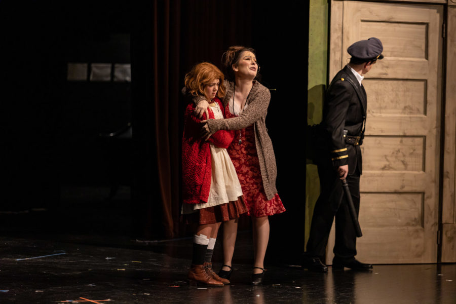 Senior Maddie Frost embraces Annie in the Tiger Theatre Companys dress rehearsal of the play Annie. The show opens Nov. 4 at 7 p.m. in the Sullivan Performing Arts Center on the Campus of Texas High School.