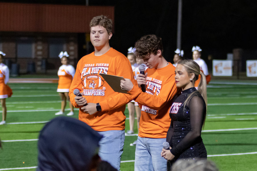 Student body officers, senior Will Carter, Ethan Power and Helen Clark Hays, read names of those who battled cancer during the playoff pep rally at Tiger Stadium Nov. 9.