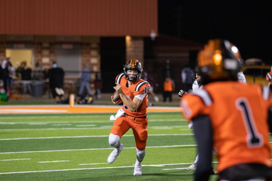 Senior Quarterback Brayson McHenry rushes towards the defensive line. McHenry scored three touchdowns in the Nov. 11 playoff game with Houston Fulshear.