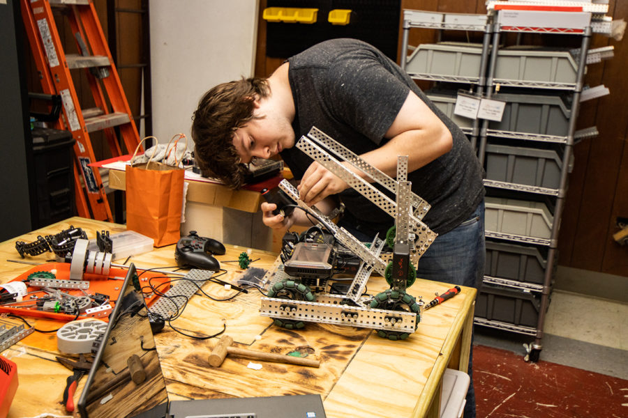 Senior Christian Cole works with a robot at a robotics practice. The T-Bots robotics team built all new robots for the upcoming competition season.