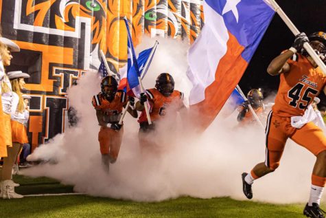 Texas High football players run through the Tiger T before their Bi-District playoff game against Houston Fulshear. The Tigers held off playoff opponents the past three week and play the Crosby Cougars in the quarterfinal round at Lufkins Abe Martin Stadium on Friday Dec. 3, 2021.