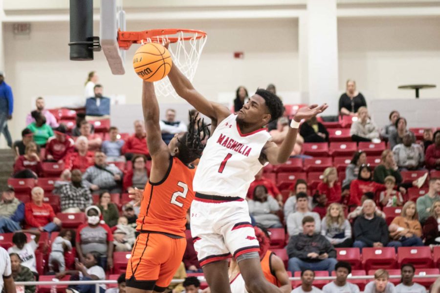 Senior Braylon Stewarts shot is blocked by Devonta Walker in the Tigers game against Magnolia Panthers on Dec. 13, 2021. The Panthers defeated the Tigers 68-39.