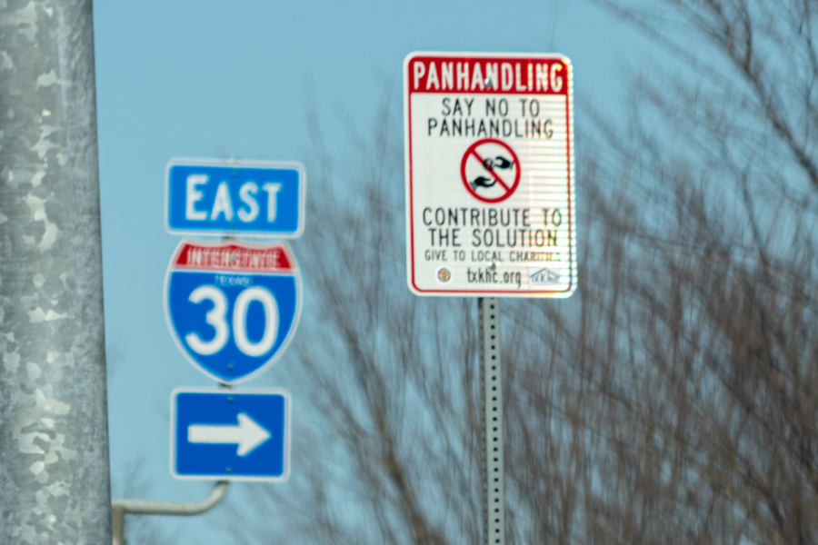 A sign discourages passersby from giving handouts to panhandlers.