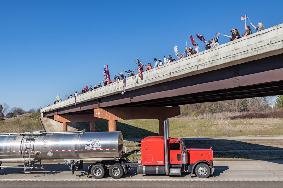 Locals line an overpass in anticipation for the “Freedom Convoy”  to stop in Texarkana. Those in support of the truckers raised funds and gathered supplies for their journey across the country to DC.