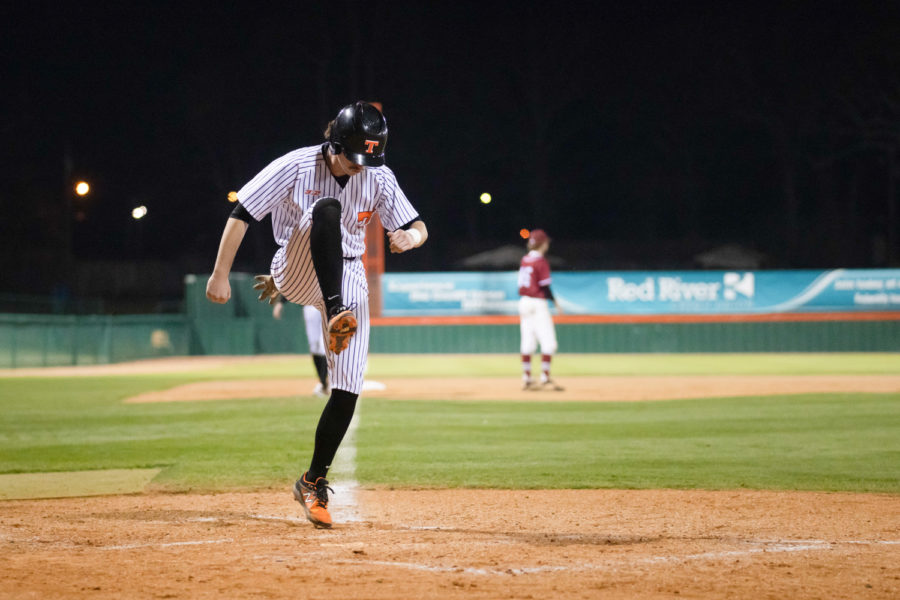 Texas Highs Robert Cheney stomps home plate as a statement to the Arkansas High team when scoring on a walk. The cross-town rivals faced off in the Border City Battle on March 5, 2022, in a tournament hosted by Texas High School.