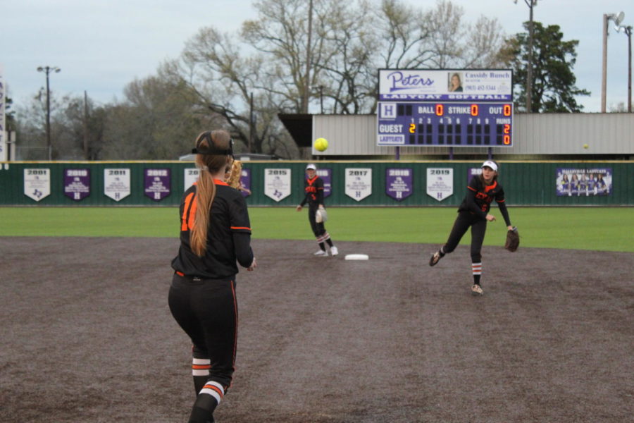 Sophomore Mally Lumpkin throws to sophomore Caitlin Salisbury in the district against against Hallsville March 22. The Lady Bobcats defeated the  Lady Tigers 8-3.