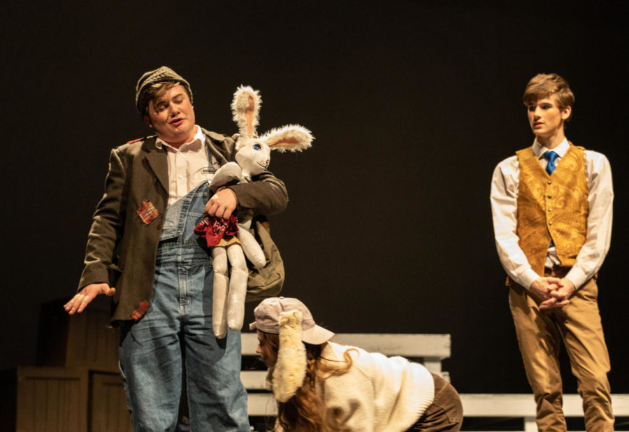 Sophomore Tyler Unger as Bull, senior Dane Bullock as Edward Tulane and sophomore Riley White as Lucy travel together during a scene in The Miraculous Journey of Edward Tulane.