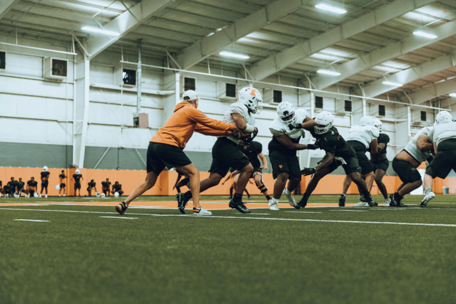 Head coach Gerry Stanford hands off the ball to a player in preparation for this weeks game. The Tigers will play Frisco Lone Star on Aug. 25, 2022.