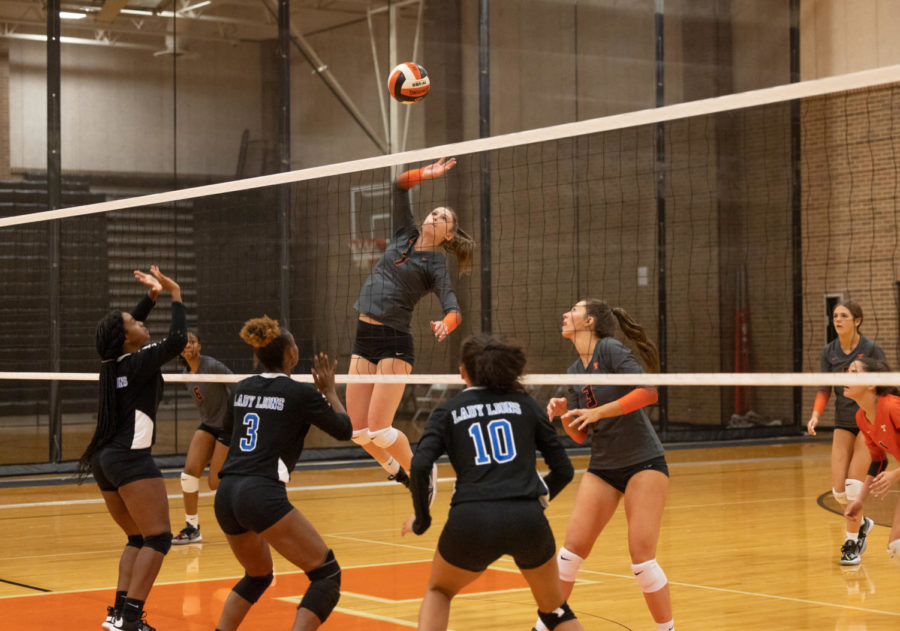 Senior Bella Cherry attacks ball in home match against Tyler. The Lady Tigers swept the Lady Lions 3-0 in their game Tuesday, Sept. 27, 2022.