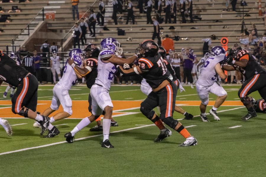 Offensive Lineman John Jack wrestles with opposing player  during the Texas versus Hallsville district opener football game on September 23, 2022. The Tigers defeated the Bobcats 56-31, winning the first game of the district season.