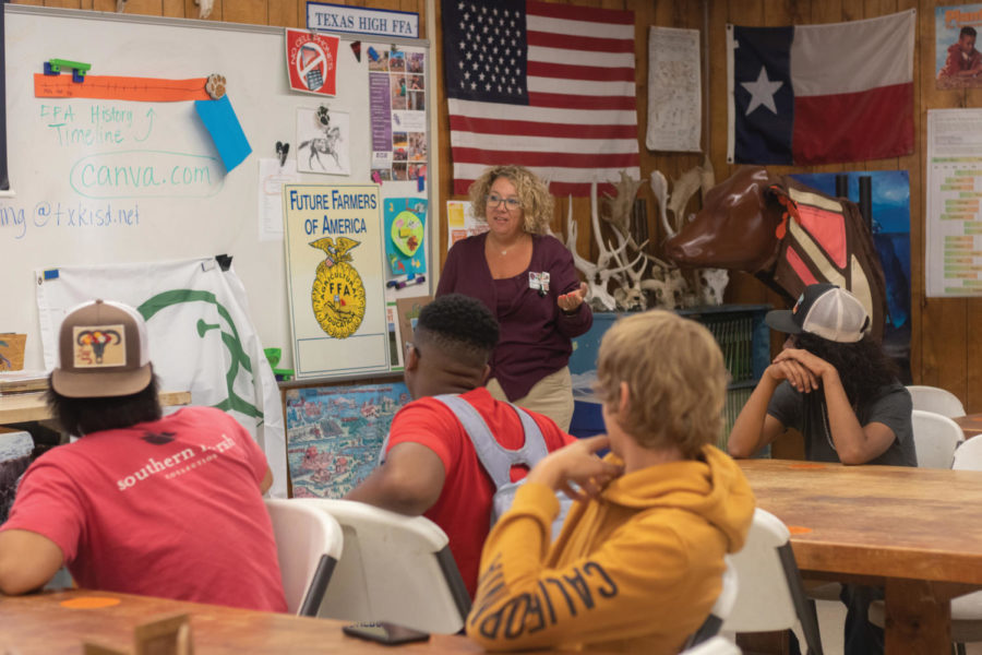 Students listen to agriculture teacher Kim Spaulding as she explains to students what FFA is and what they do. 