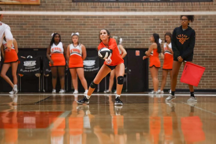 Sophomore liber Carlyn Clack passes a ball in district match against the  Longview Lady Lobos. The Tigers swept the Lobos 3-1 in their second district match, making their district record 2-0.