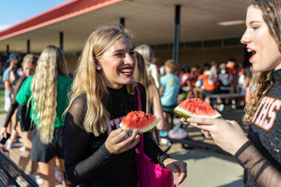Senior Lydia Horton enjoys spending time with her sister at her last watermelon supper as a student at Texas High School. The students enjoyed watermelon before the pep rally started on Aug. 15, 2022.