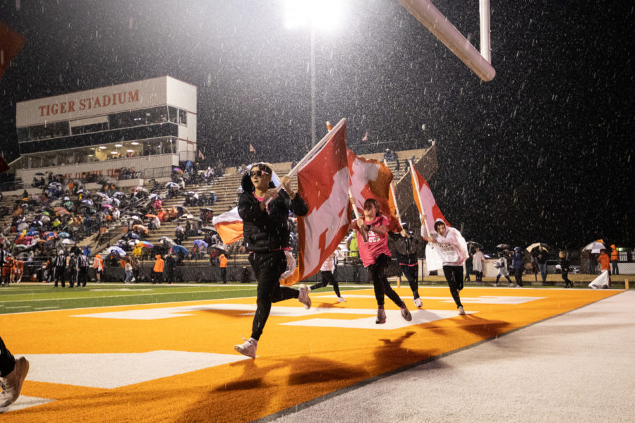 Cheer escorts run flags across the end-zone after a touchdown by the Texas High football team in the Texas versus Whitehouse district game. The Tigers were defeated by the Wildcats 32-27, losing the competition for district champs. 