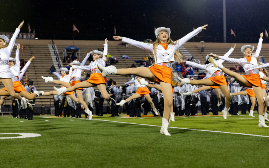 Senior Lizzie Debenport prepares to leap in the air while performing during the Texas HighSteppers halftime performance. Tigers were defeated by the Wildcats 32-27, losing the competition for district champs.