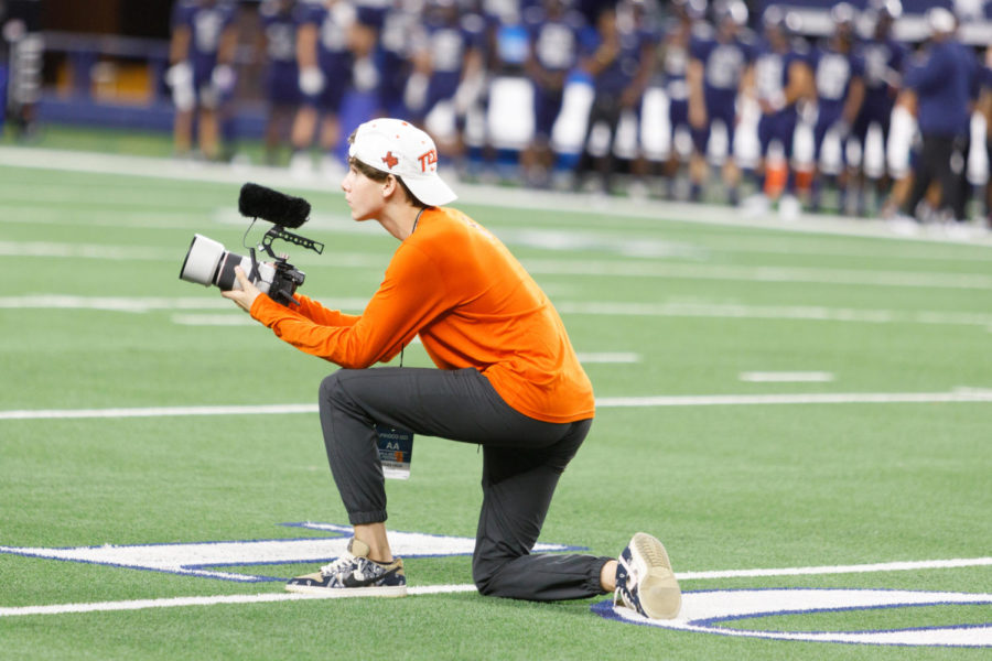 Senior Jackson Haltom shoots video of the Texas High football team. He has become known for his memorable sports videos.