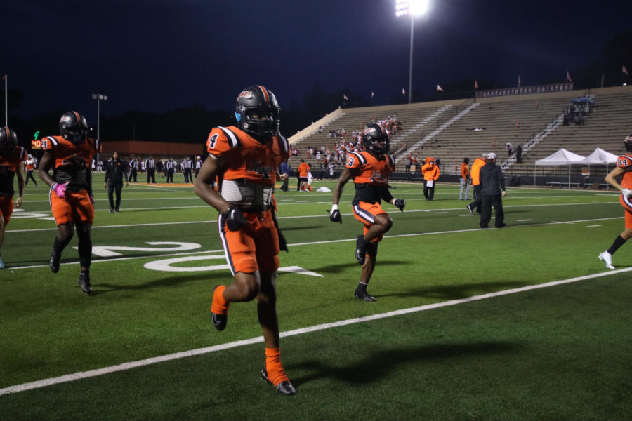 Sophomore Javari Johnson does high knees in warm-ups for district match against Whitehouse Friday, Oct. 28, 2022. The Tigers will be competing to defend their district championship and keep their home winning streak alive. 