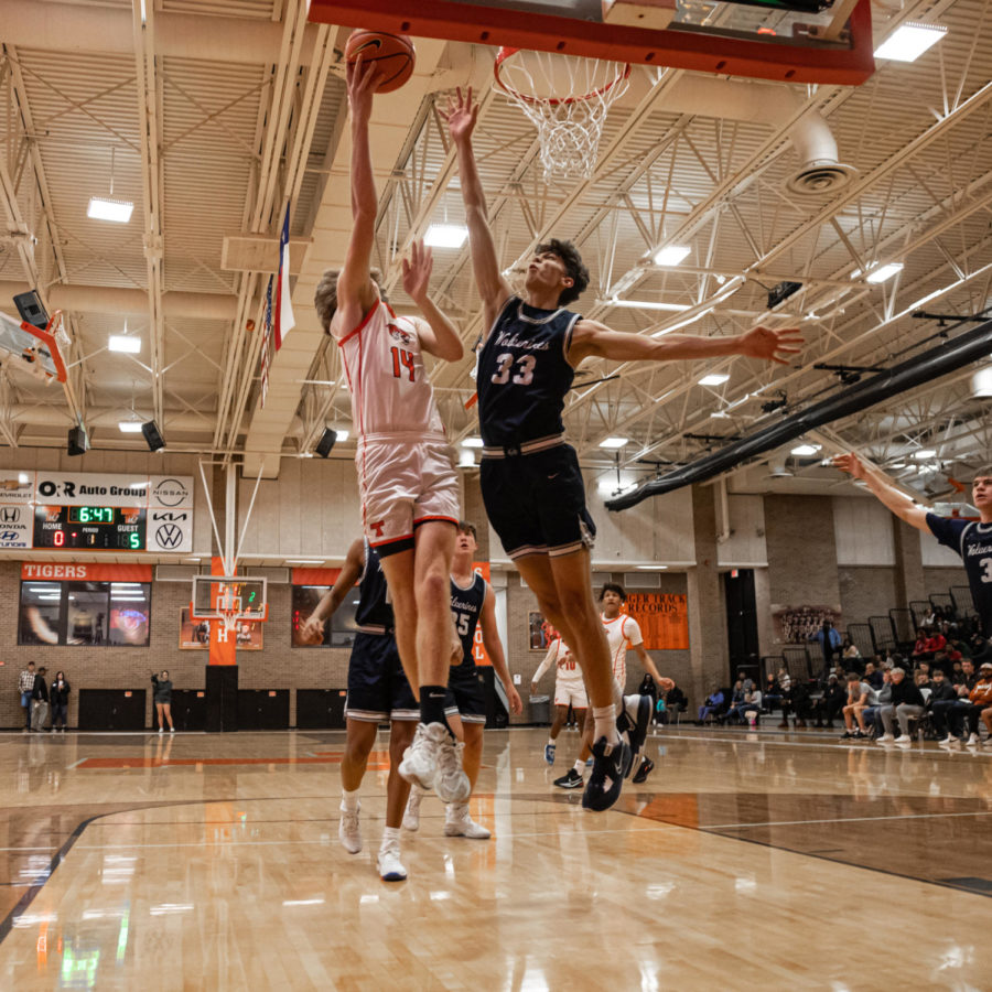Sophomore David Potter goes in for a layup in their game against Bentonville West Friday, Dec. 2, 2022. The Tigers got their first victory I n day two of Hoopfest against Airline 69-61, Dec. 3, 2022.