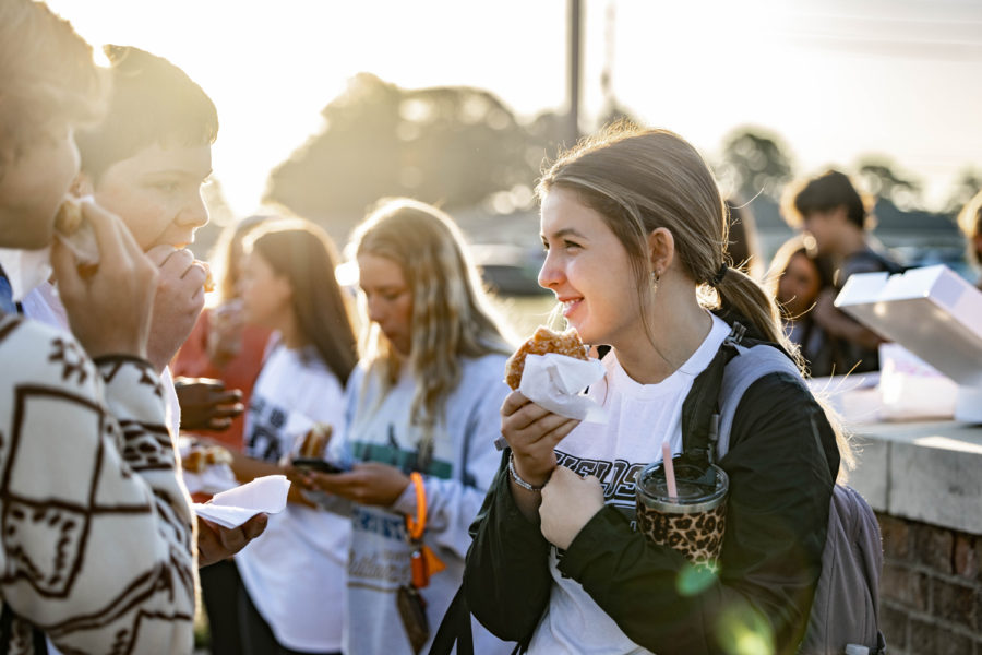 Sophomore Kynlee Flippen socializes while waiting for See You At The Pole to begin on September 28, 2022. The  annual event involves Texas High students of faith meeting at the flag pole for a quick worship service before school. 