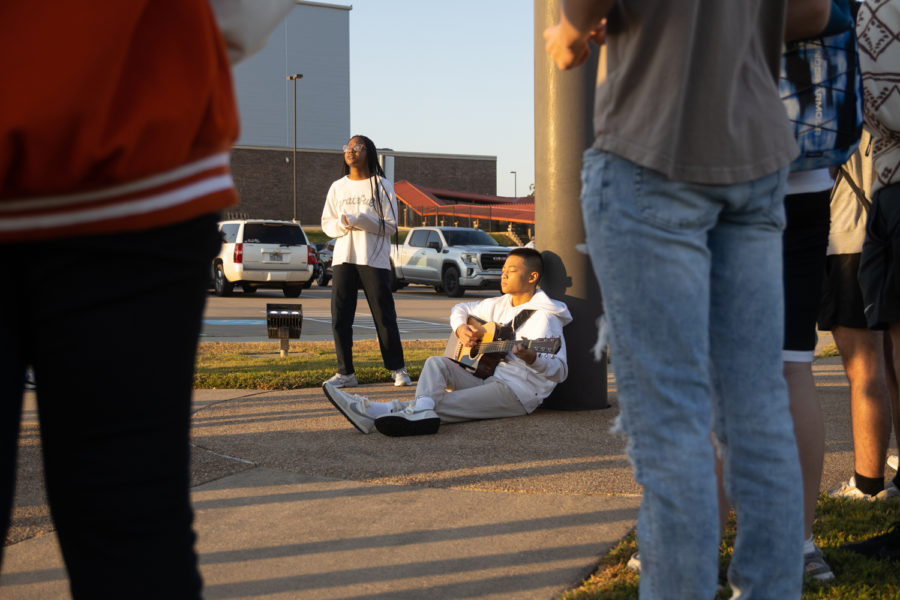 Juniors Salem Alonge and Nash Orena sing a song during the annual See You At The Pole meeting on September 28, 2022. Every year, Texas High Students of faith gather at the flag pole to worship before school.
