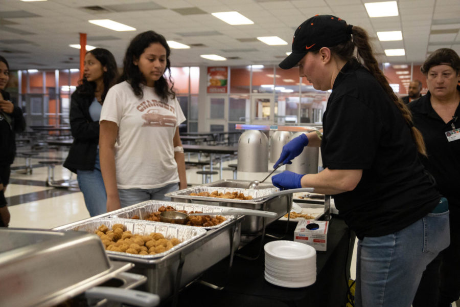 TISD menu development specialist serves food to students participating in the test testing. The school will use the reviews of students to determine a new menu for next school year.