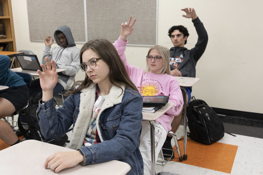 Juniors Zoe Vanderhoof, Darbi Davis and Brendan Allred participate in hands up for understanding. Students and teachers alike share mixed feelings over the newly integrate Kagan strategies.