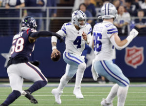 Dallas Cowboys quarterback Dak Prescott (4) keeps the ball and looks to get a first down against the Houston Texans during the third quarter at AT&T Stadium on Dec. 11, 2022, in Arlington, Texas. (Tom Fox/The Dallas Morning News/TNS)
