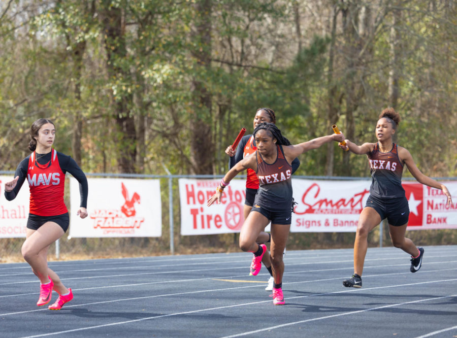 Freshman Kyleigh Perkins receives baton from junior Keira Collins in the varsity girls 400 meter relay at the Mav Relays track meet Saturday, Feb. 18, 2023. The varsity girls finished third overall with a total of 80 points in the meet. 