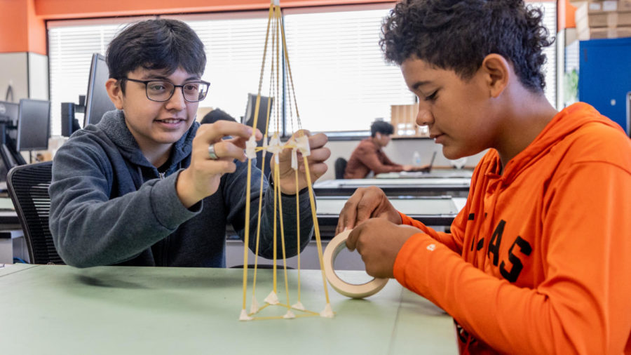 Freshmen Jared Segura and Eli Shelley use spaghetti and tape to construct a tower. This was part of the architecture class here at Texas High.