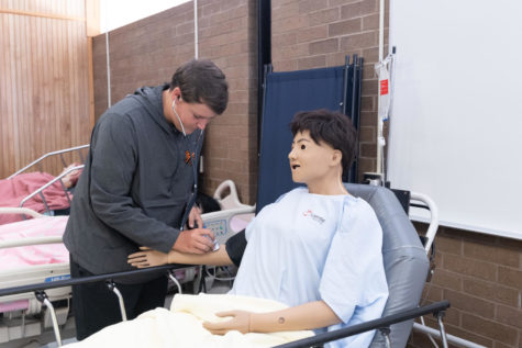 Sophomore Ben Maxey uses a patient simulation to practice taking a patients pulse. Health Science prepares students for higher level medical classes and is an introduction to the medical field.