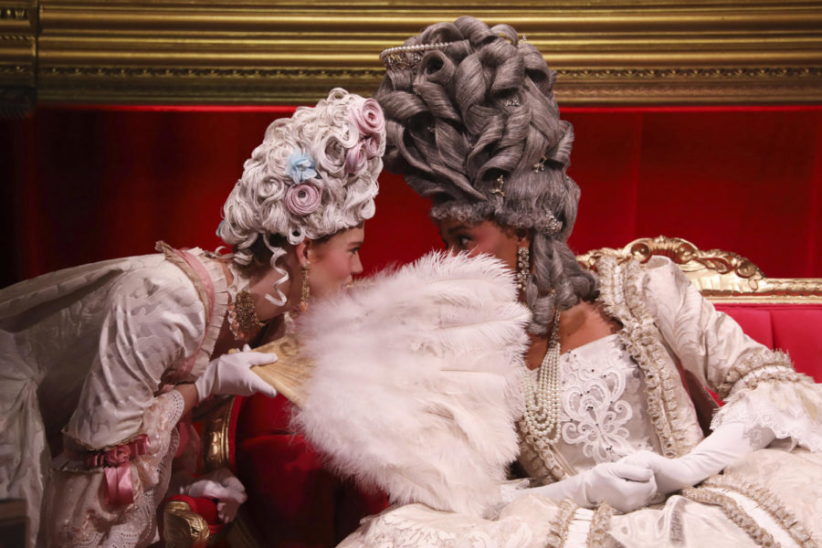 The lady-in-waiting whispers to Queen Charlotte during The Queens Ball: A Bridgerton Experience, at XS Tennis and Education Foundation, on April 21, 2022, in Chicago. (John J. Kim/Chicago Tribune/TNS)