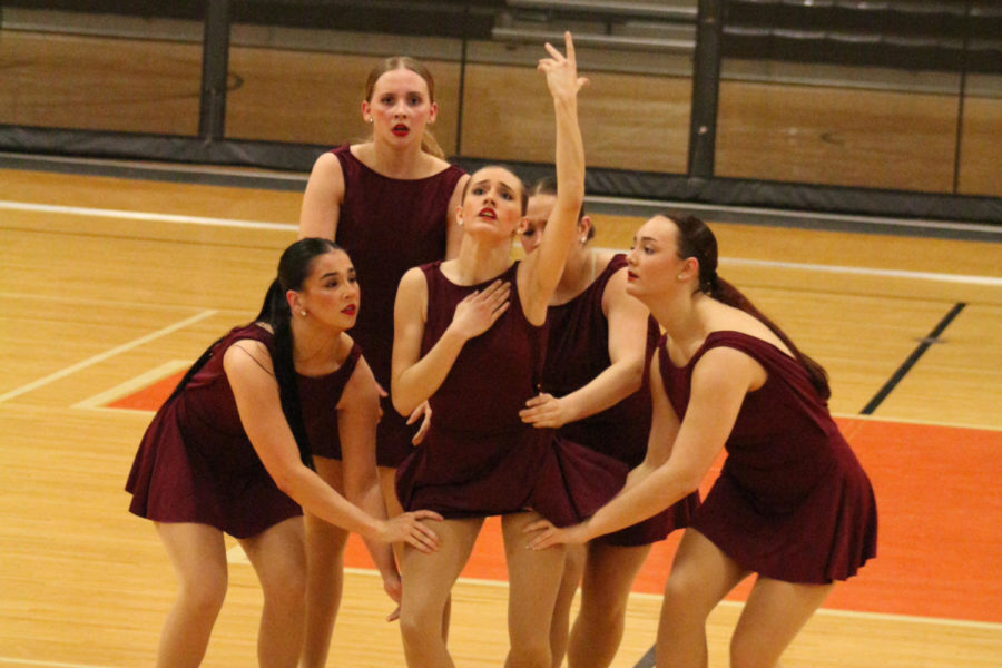Senior Lydia Horton, surrounded by other officers, dances to To build a home. The Texas Highstepper officers performed their officer Modern dance at the Danceline USA North Texas Regional Competition in Celina, TX.