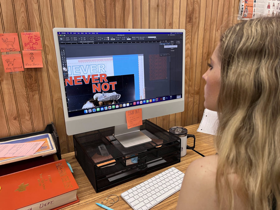 Senior Lydia Horton works on a page of the Texas High yearbook. While yearbook works all year to complete their book, newspaper must consistently put out stories each week.
