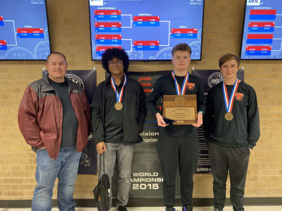 Juniors+Aidan+Spivey+and+Brett+Sparks%2C+Sophomore+Evan+Wyche+and+robotics+sponsor+Mark+Ahrens+pose+with+their+semi-finals+plaque.+Texas+High+had+two+teams+compete+at+UIL+State+in+Houston%2C+TX.