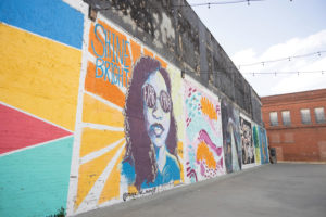 Downtown lies Kress Gap, a wall full of murals attracting the public. 