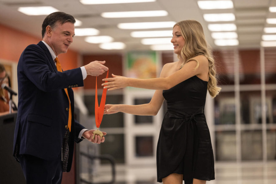 Sophomore Lauren Friday   is awarded a medal by Superintendent Dr. Bob Brubaker for an outstanding PSAT score. The National Merit Scholars also received their awards at the reception.