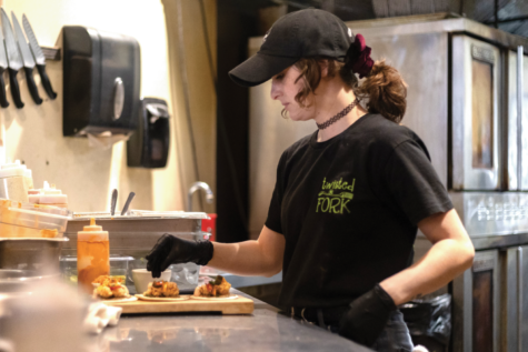 A Twisted Fork employee prepares tacos. Twisted From has a variety of foods for their customers to choose from.