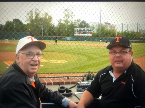 Keith Schutte (right) sits on alongside the Tiger baseball field with Al Hannah (left). Schutte acted as the Voice of the Tigers for twelve years as of 2023 before passing.