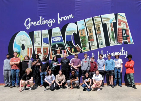 Band students stand alongside their directors in front of a mural on their trip to OBU. Students spent their time learning new skills such as identifying certain pitches.