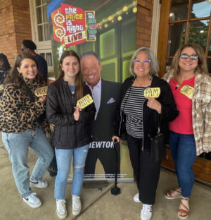 Junior Anna Bius stands among her family holding  her ticket from The Price is Right Live on April 23, 2023. The game show went live at Ross Perot Theatre, giving local fans a chance to experience it in real time. 

