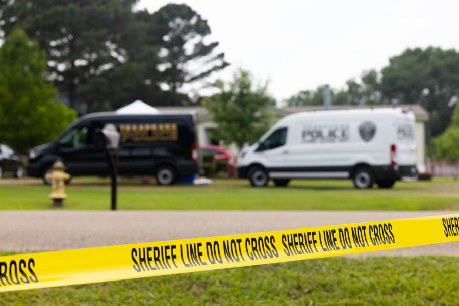 Crime scene vehicles sit outside of a home off of Lemon Acres Lane in Nash, Texas where four people were murdered on May 23, 2023. Police arrested the suspected shooter after a standoff that lasted several hours. 