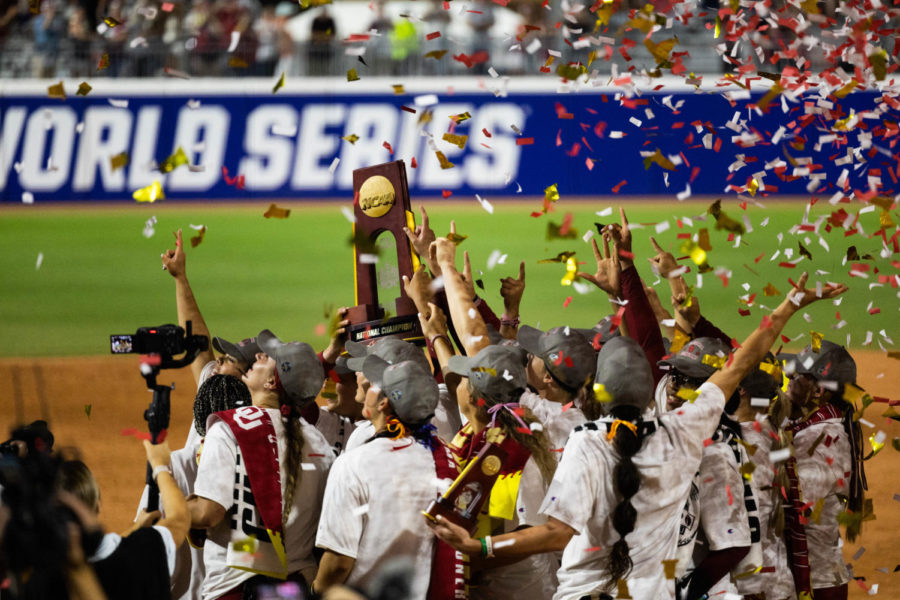 The Oklahoma Sooners hoist the NCAA Womens College World Series Trophy as crimson confetti rains down. This marked the Sooners third consecutive national title, and the sixth in the ten years.