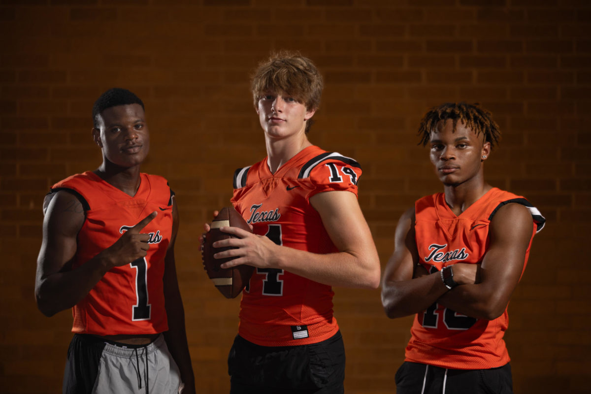 Senior TJ Gray, juniors David Potter and Julius George stand in to be honored as footballs off-season Faces of the Game.