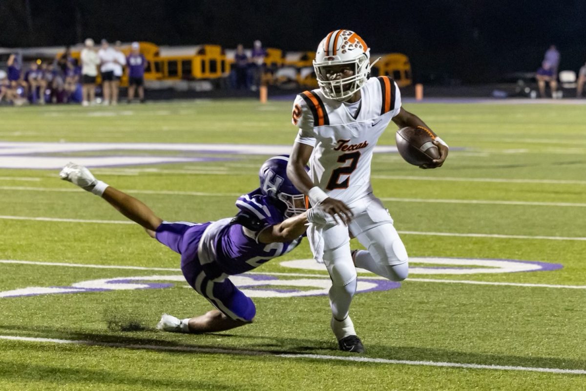 Sophomore Kam Wrightner escapes pocket in first district game against Hallsville Friday, Sept. 22, 2023. The Tigers took the win 42-7, making their district record 1-0.